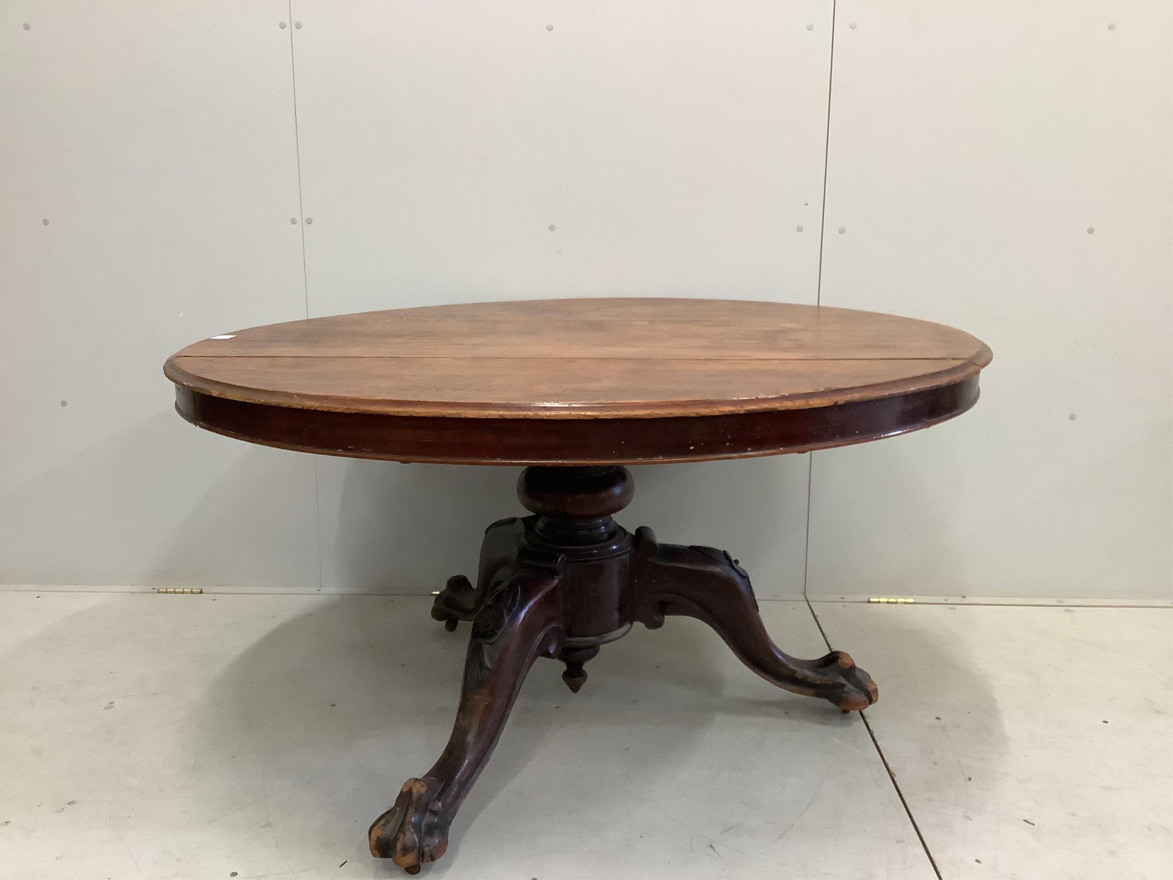 A Victorian circular mahogany tilt top tripod breakfast table with claw feet, diameter 136cm, height 72cm. Condition - poor